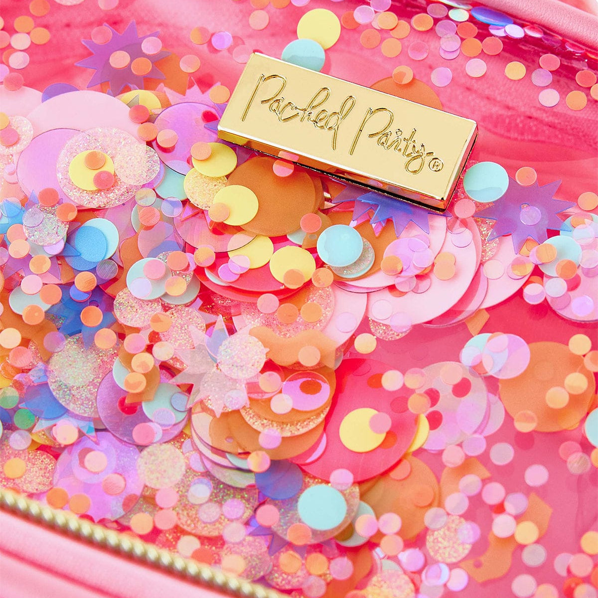 Close-up of multicolor confetti and the Packed Party logo on the clear pink mini backpack.