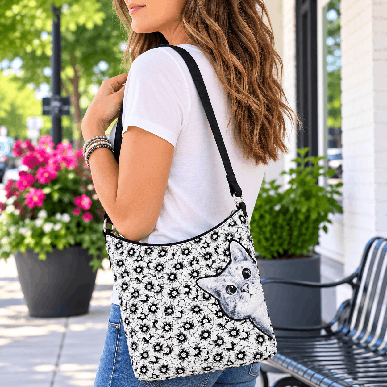 Woman carrying the peekaboo cat floral canvas shoulder bag during everyday