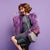 Woman wearing purple with gray shoulder bag | Pakapalooza