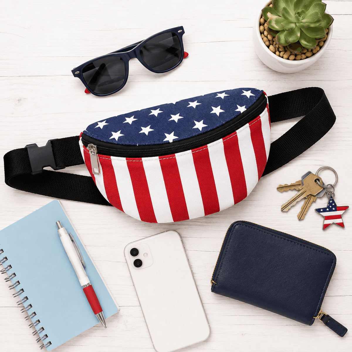 American Flag Fanny Pack displayed with everyday essentials including sunglasses, phone, wallet, keys, and travel accessories.