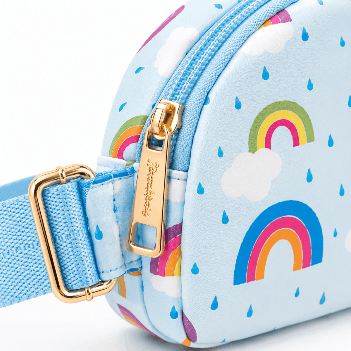 Close-up of the April Showers Belt Bag showing the rainbow print, gold-tone zipper pull, and adjustable strap hardware.