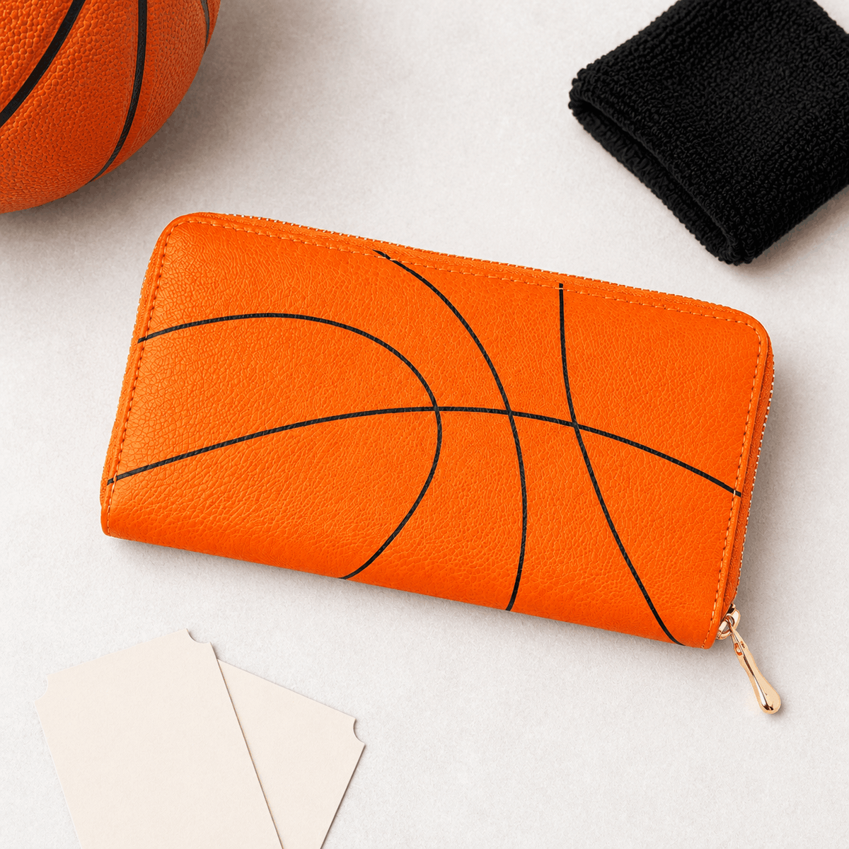 Orange basketball zipper wallet in a game-day flat lay
