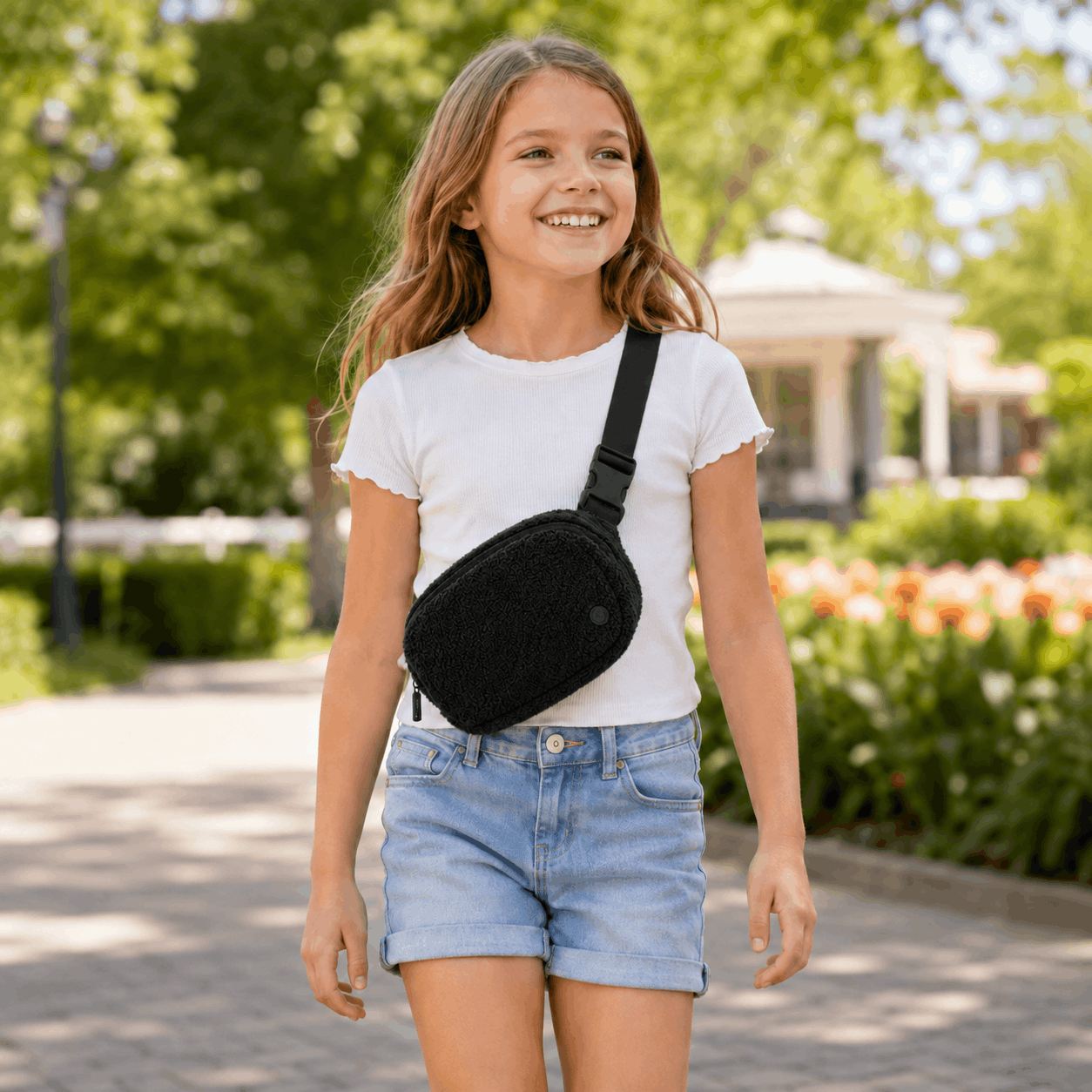 Child wearing the Black Fleece Belt Bag crossbody at a park