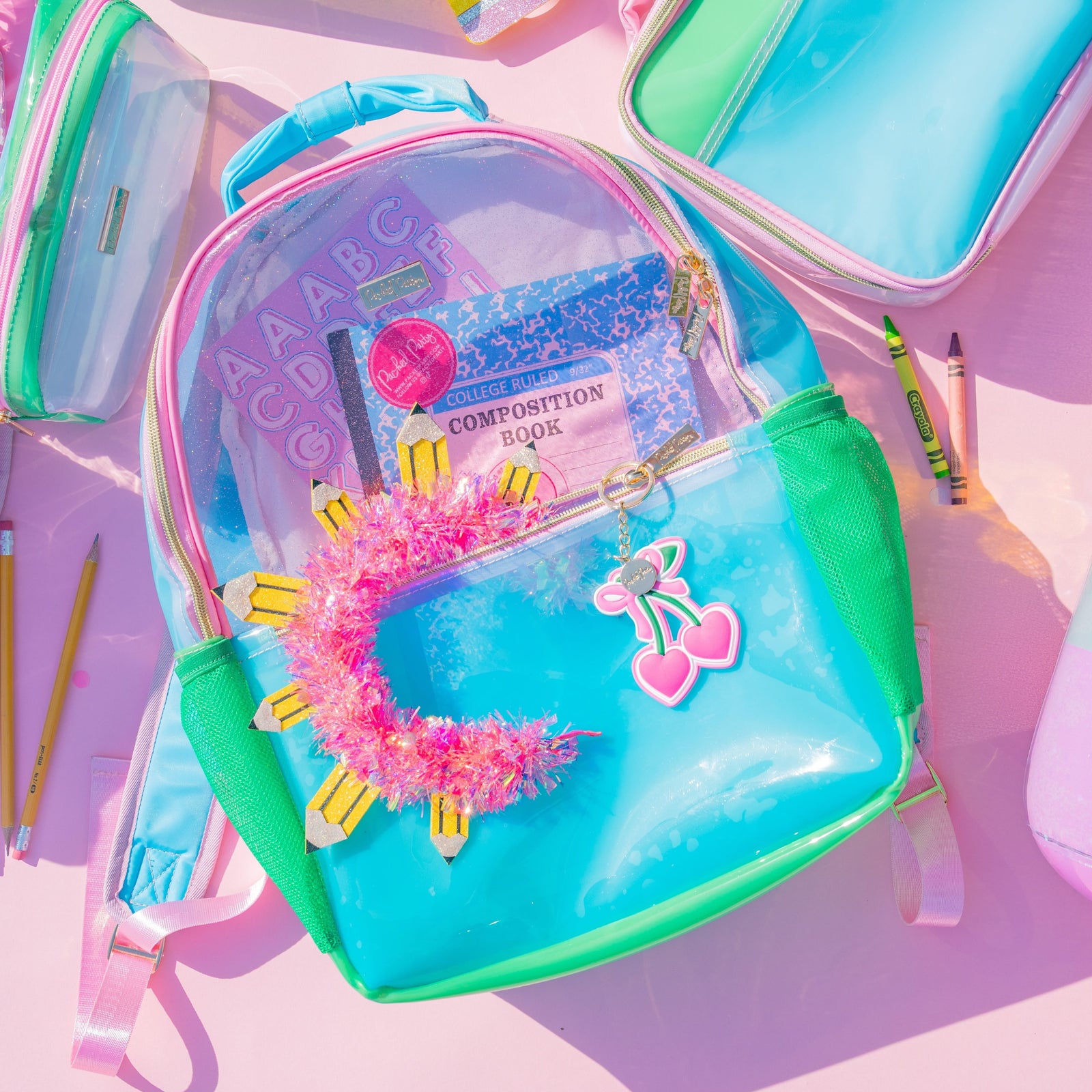 Clear Color Block Jelly Backpack packed with colorful school supplies in a flat lay.