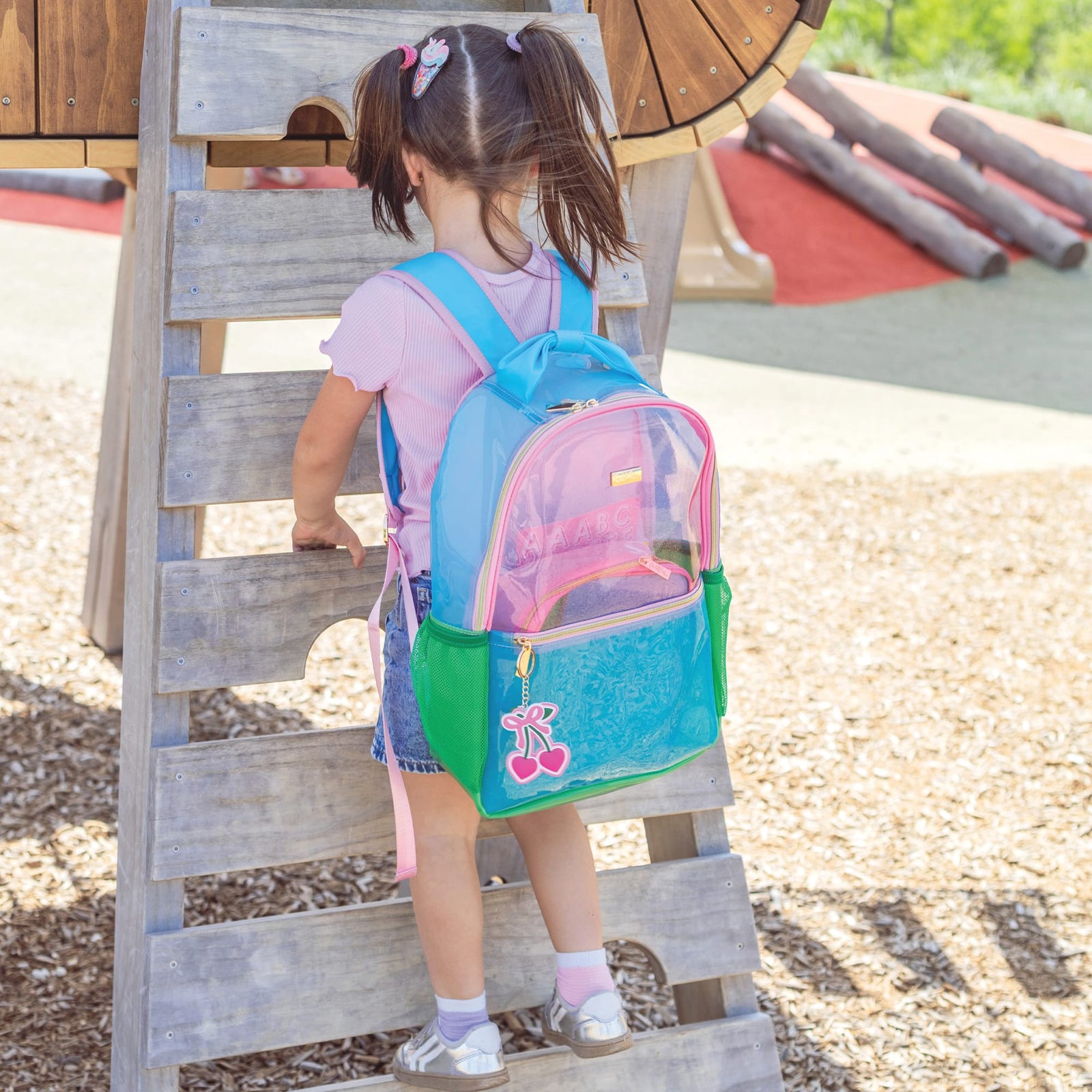 Child wearing the Clear Color Block Jelly Backpack outdoors.