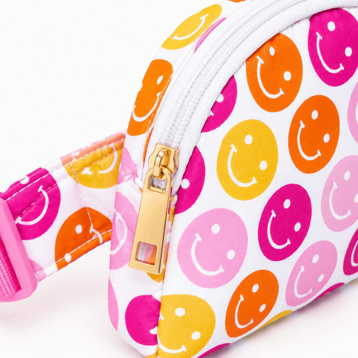 Close-up of the Don't Worry Be Hippy belt bag showing the colorful smiley face print, gold zipper pull, and stitching