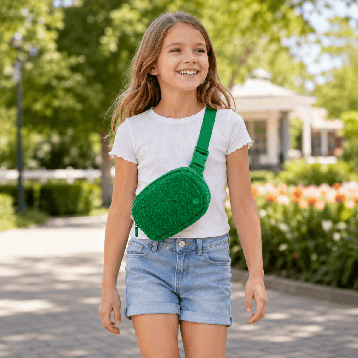 Child wearing the Green Fleece Belt Bag crossbody at a park