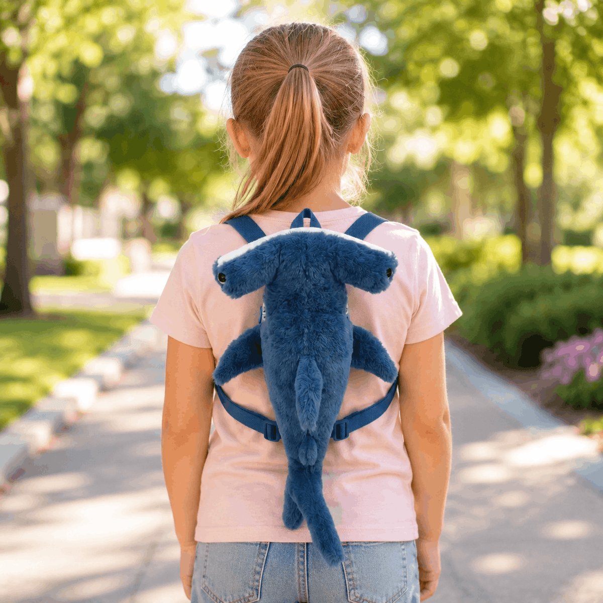 Child wearing the Hammerhead Shark Plush Mini Backpack outdoors