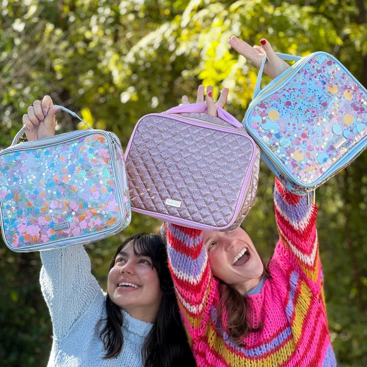 Multicolor Confetti Insulated Lunchbox held outdoors with other colorful Packed Party lunch bags.