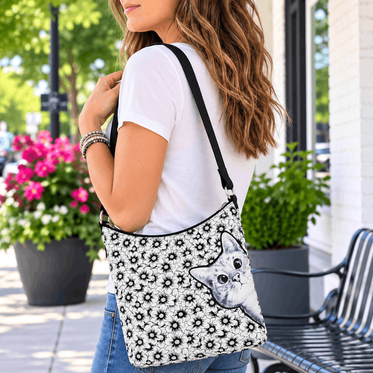 Woman carrying the peekaboo cat floral canvas shoulder bag during everyday