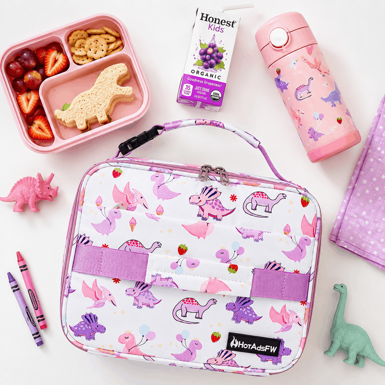 Pink Dinosaur Kids Insulated Lunch Box styled with lunch essentials on a bright flat lay background.