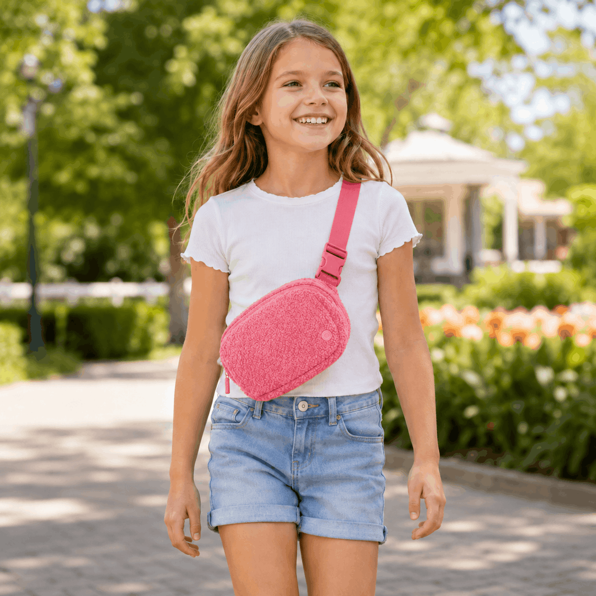 Child wearing the Pink Fleece Belt Bag crossbody at a park