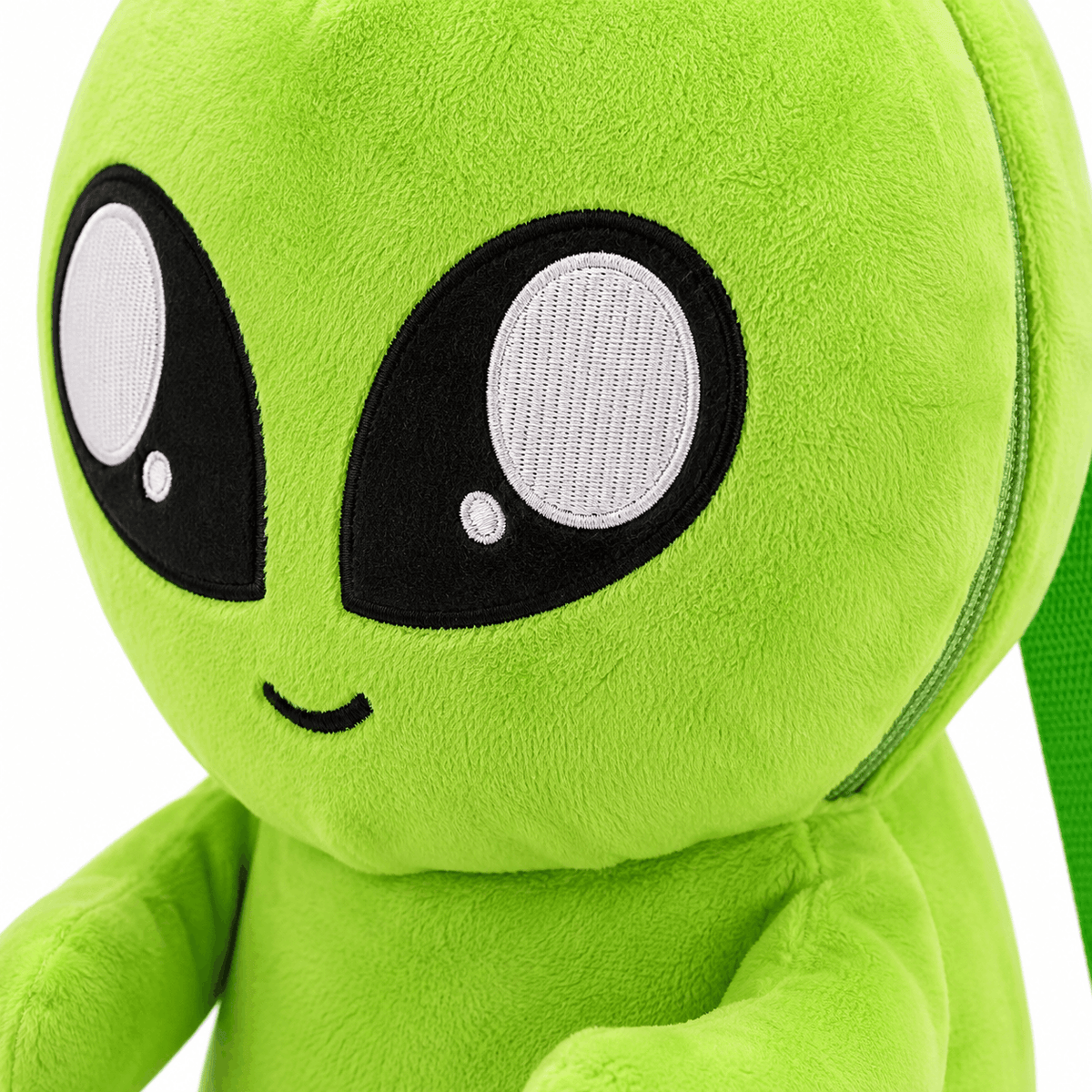 Close-up of the Plush Baby Alien Mini Backpack highlighting the embroidered eyes, smile, and soft plush texture.