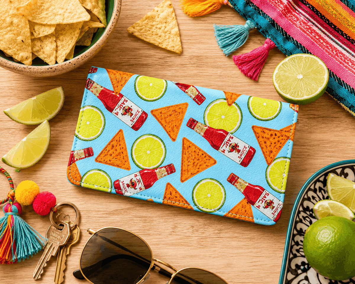 Spicy Fiesta bifold wallet displayed with colorful fiesta-inspired accessories, tortilla chips, and fresh limes