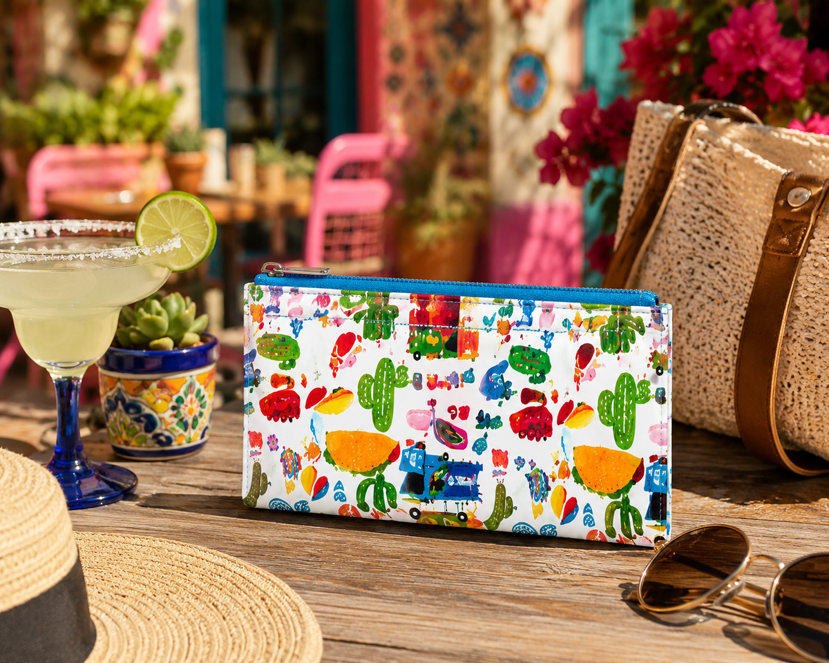 Taco Fiesta Coin Wallet displayed on an outdoor café table with sunglasses, coffee, and colorful accessories.